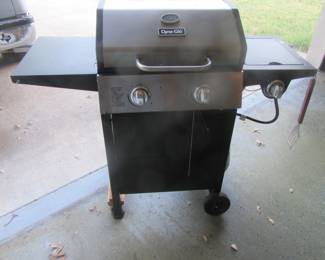 Propane outdoor cooker with propane bottle.