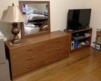 This picture shows not only the six-drawer dresser, but the large mirror, a small bookcase, and video monitor. And a table lamp.