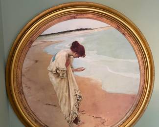 This round piece of a woman collecting shells on the beach has a certain appeal.