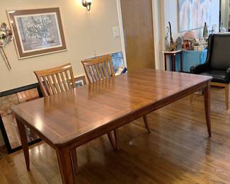 This is the large dining table, with two of the four matching chairs on the far side.