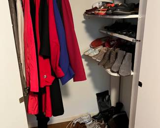 A second closet has a different set of clothing and a decent set of shoes.
