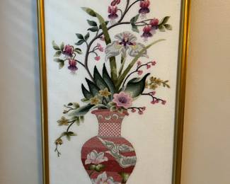 This is a nice framed art piece. This vase shows several flowers for an interesting image.