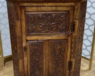 Carved corner cabinet
