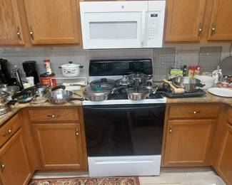 Nice pots & pans, glass baking dishes, mugs & coffee pots, canned & boxed food, glasses , etc.