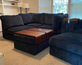 C19 - $3250. Lovesac "Sactional" Midnight Blue. 6 seat - 8 Side Modular Sectional in excellent condition. 1 Charge Side. Lovesac pillows and blankets included. Includes 2 tables & 3 cup holders. Each module measures 35" Wide x 29" Deep seats Measure 35" x 35". (This retails for over 6k)