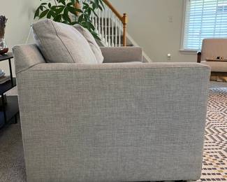 C10 - $650. Crate & Barrel Gray Loveseat. This is in very good condition. Measures 76.5" Wide x 18.5" Deep x 29" Tall. Fabric : Galaxy Ash (Retails for $1399.)
