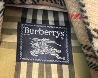 D25 - $250. Burberry Trench Coat with wool liner. No size tag - looks like a large.
