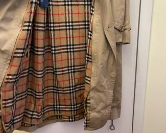 D25 - $250. Burberry Trench Coat with wool liner. No size tag - looks like a large.