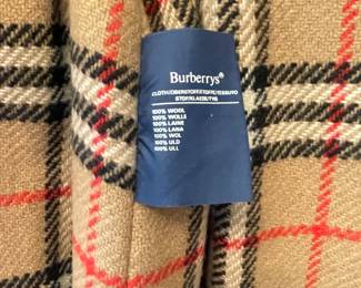 D25 - $250. Burberry Trench Coat with wool liner. No size tag - looks like a large.