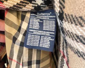 D25 - $250. Burberry Trench Coat with wool liner. No size tag - looks like a large.