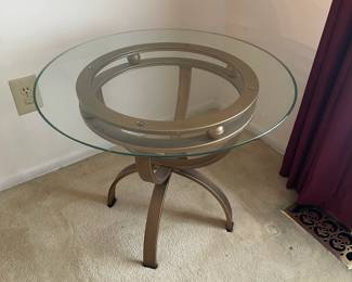 D8 - $45. Round glass and metal side table. 26"round 21"tall.