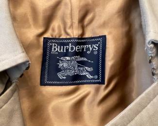 D25 - $250. Burberry Trench Coat with wool liner. No size tag - looks like a large.