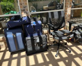 Suitcases and office chair and multiple home board games