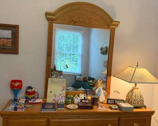 Dresser with mirror, pretty painted lamp, nice items on the dresser.
