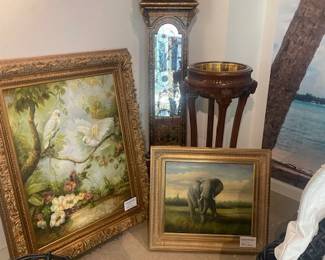 Oil paintings with a mirrored clock and vintage plant stand