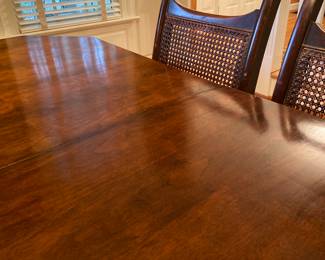 Polished top of the antique dining table, 58 1/2” x 44”, includes on 11 1/2” leaf and includes table pads