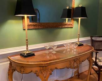 Ornate antique carved console table that has been in the family for decades. Shown with gilded mirror