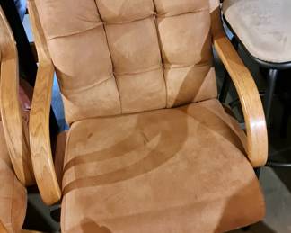 One of 4 upholstered arm chairs on swivel base