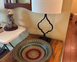 Lamp, solid wood table, decorative bowl.