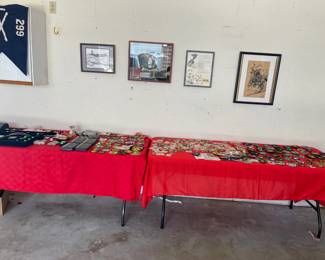Two tables full of Military / Police challenge coins and patches. 