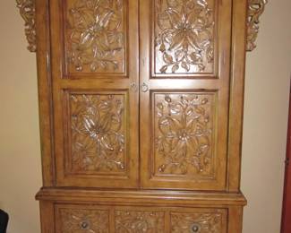 ornately carved armoire