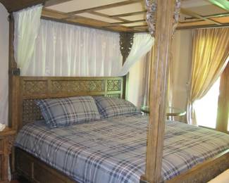 ornately carved king size canopy bed