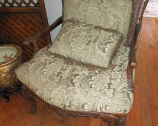 carved mahogany arm chair with caned back and seat