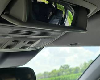 Sunglasses holder thingy on the ceiling doubles as a "spy on the kids" gadget.