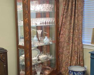 Beautifully carved, lit China cabinet with side entry doors and mirrored bottom