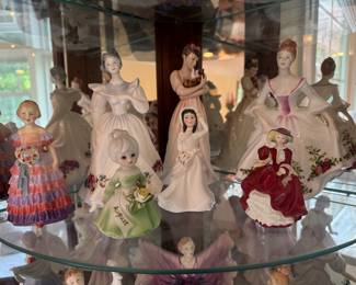 Royal Doulton "The Little Bridesmaid" Porcelain Figurine (Far Left), Royal Doulton "Figure Of The Month 'December' C. 1987, Elegance In Motion Christmas" Porcelain Figurine (Left Middle), Brinn's Birthday Girl "August" Porcelain Figurine (Small Green), The Royal Doulton "Helen" Porcelain Figurine (Small Middle), Royal Doulton "Kimberley" Porcelain Figurine (Large Middle), Royal Doulton "Top o' the Hill" Porcelain Figurine (Right Front), Royal Doulton "Country Rose" Porcelain Figurine (Right Back)