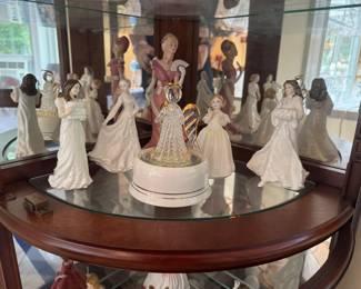 Royal Doulton "Christmas Parcels" Porcelain Figurine (Left Front), Royal Doulton "Remembering You" Porcelain Figurine (Left Middle), Lenox "Royal Reception" Porcelain Figurine (Rear Middle), Dura Best Angel Rotating Music Box (Center), Royal Doulton "Catherine" Porcelain Figurine (Center Back Right), Royal Doulton "Pretty Ladies" Porcelain Figurine (Far Right)