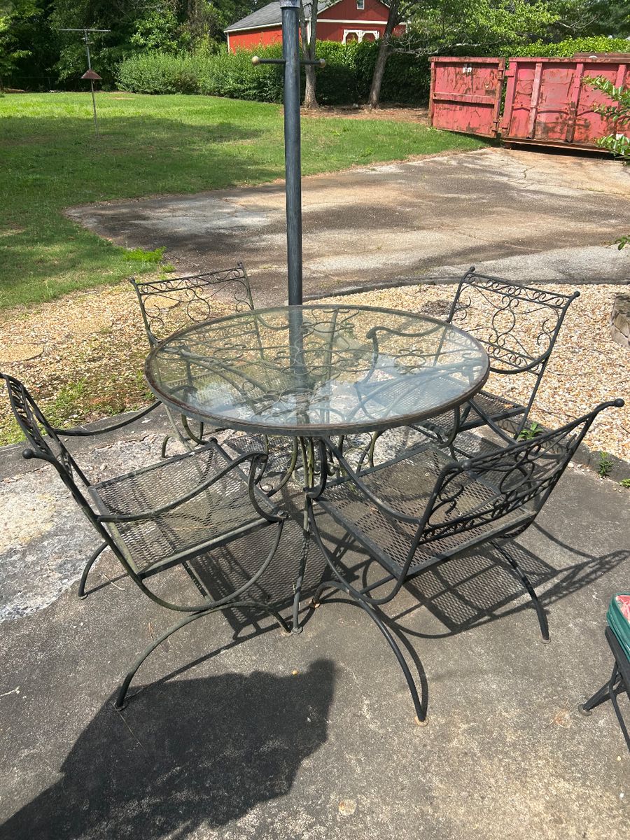 Wrought Iron patio set with 4 chairs and glass top