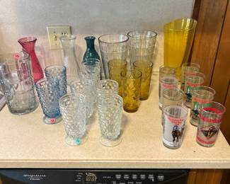 Vintage glassware and Kentucky Derby glasses various years .