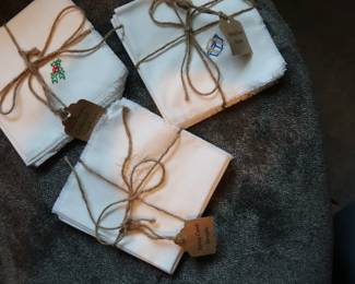 Charming linen napkins from Spring Creek Designs. Each features festive embroidery and rustic twine packaging. Perfect for hosting or gifting.