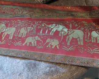 Thai Elephant Tapestry Runner – Long Format
Woven textile featuring gold elephants and traditional Thai motifs. Likely poly-silk blend. Beautiful as a table runner or wall accent.