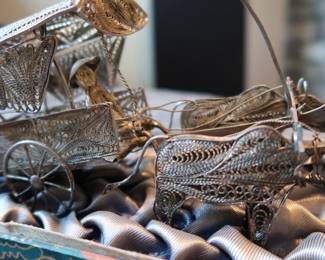 Decorative miniature ox and horse-drawn carts crafted with fine metal filigree-style detailing. These pieces were acquired during the world travels of a retired couple and showcase ornate design and cultural charm. Not silver, but still striking in appearance—perfect for display or resale in home décor or vintage markets.
As a Set: $20–25
Individually: $10–15 each