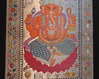 Large Framed Embroidered Ganesha Textile Art
Intricately embroidered textile of Lord Ganesha, featuring metallic and colored threadwork on silk or silk-blend fabric. Framed and protected under glass. Picked up during the couple's world travels.