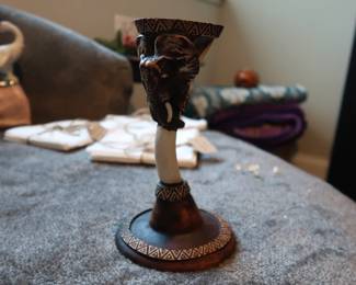 Hand-Carved Elephant Candle Holder – Tribal Design
Decorative elephant-themed candle holder with carved geometric pattern. Likely hand-crafted in Africa or inspired by traditional African art. Material appears to be resin or wood composite. Collected during travels in Africa – artisan piece