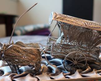 Decorative miniature ox and horse-drawn carts crafted with fine metal filigree-style detailing. These pieces were acquired during the world travels of a retired couple and showcase ornate design and cultural charm. Not silver, but still striking in appearance—perfect for display or resale in home décor or vintage markets.
As a Set: $20–25
Individually: $10–15 each