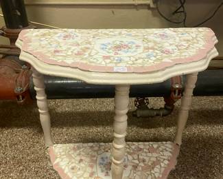 Pastel floral mosaic on wood shelf