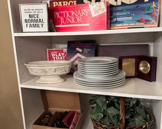 White bookshelf, board games, dishware, glasses