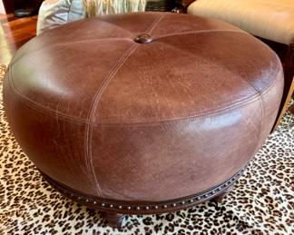 (SOLD; leather ottoman with nail head trim; 32"dx17"h)  (SOLD; real hide rug with printed leopard pattern; approx 5'x7')