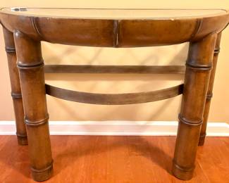 $400; demi-lune wood table with rattan-look, glass top with metal scrolling under glass; 48x22x32