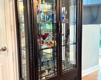 $1200 A.R.T. Furnishings black curio cabinet with paned glass doors and one drawer; 42L x 15W x 85H
