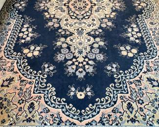 $350; large area rug with navy primary color and cream and pale blush accent colors; approx 8'x11'