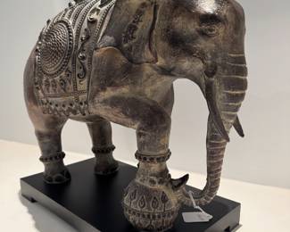 $60 Regal ceramic elephant with one leg resting on a ball; 18L x 8.5W x 17H
