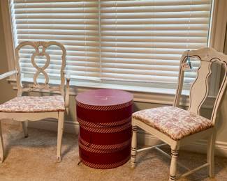 white chairs and red hat boxes