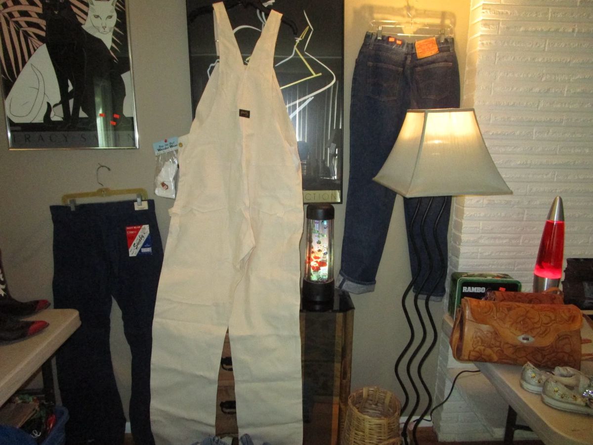 Post Moden mirrored end table, lamp, lava lamp, 1980's framed art, Vintage denim including Stan Ray new/old stock with tags coveralls, Levis with "wash em hot" tag and so much more. Piles of denim!