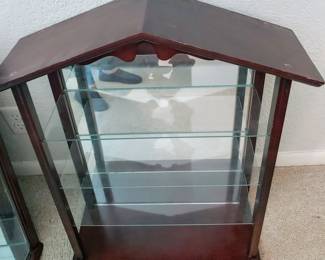 Wall display with glass shelves, mirrored back.
