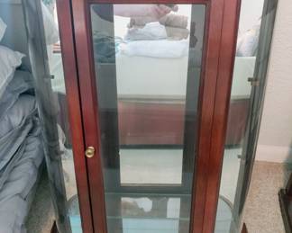 Wall display with glass shelves, mirrored back.